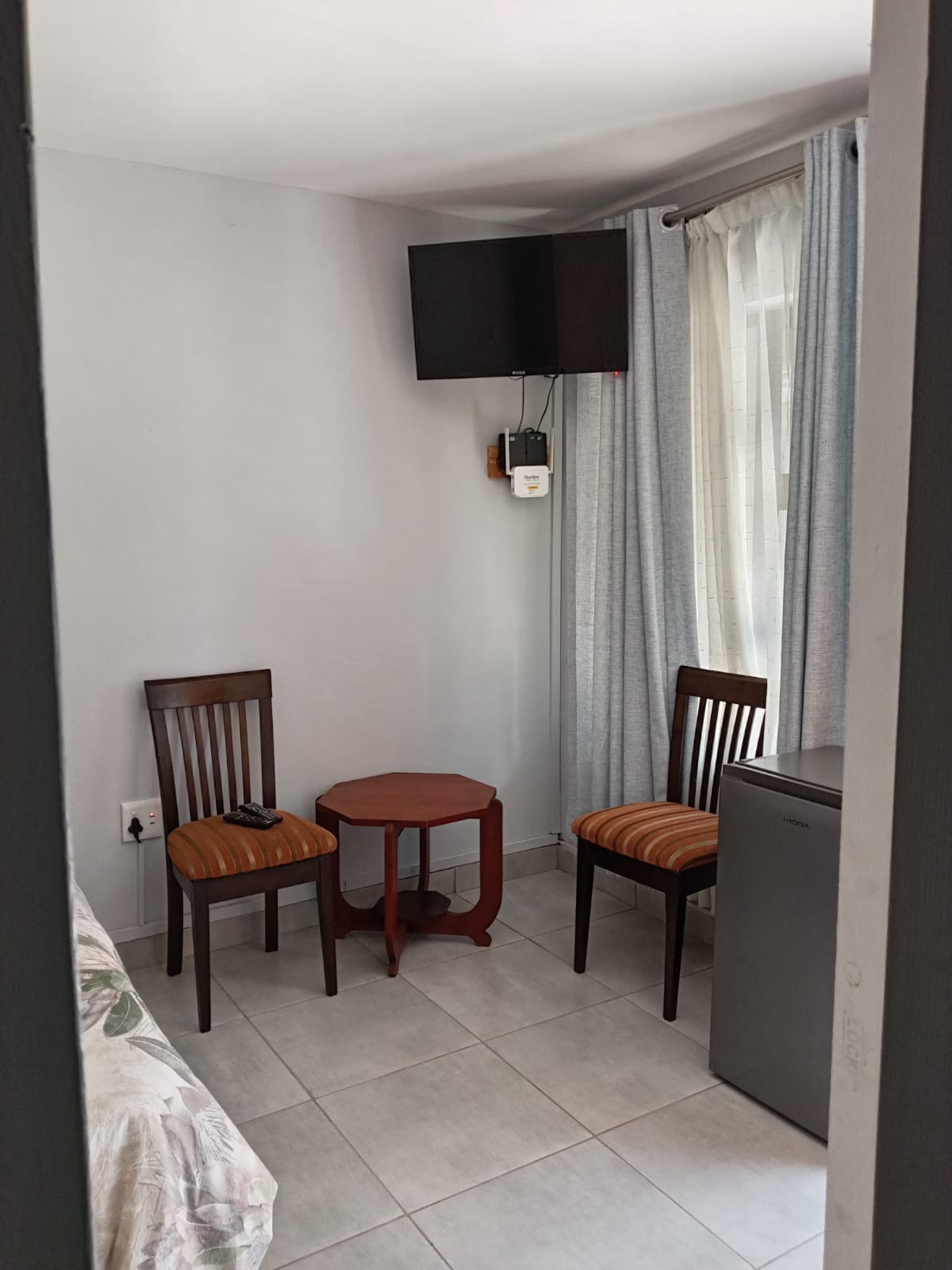 Seating corner with TV, bar fridge and table